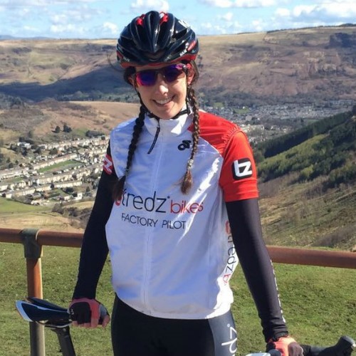 Danni posing for a photo with a typical south walian valleys scene behind her